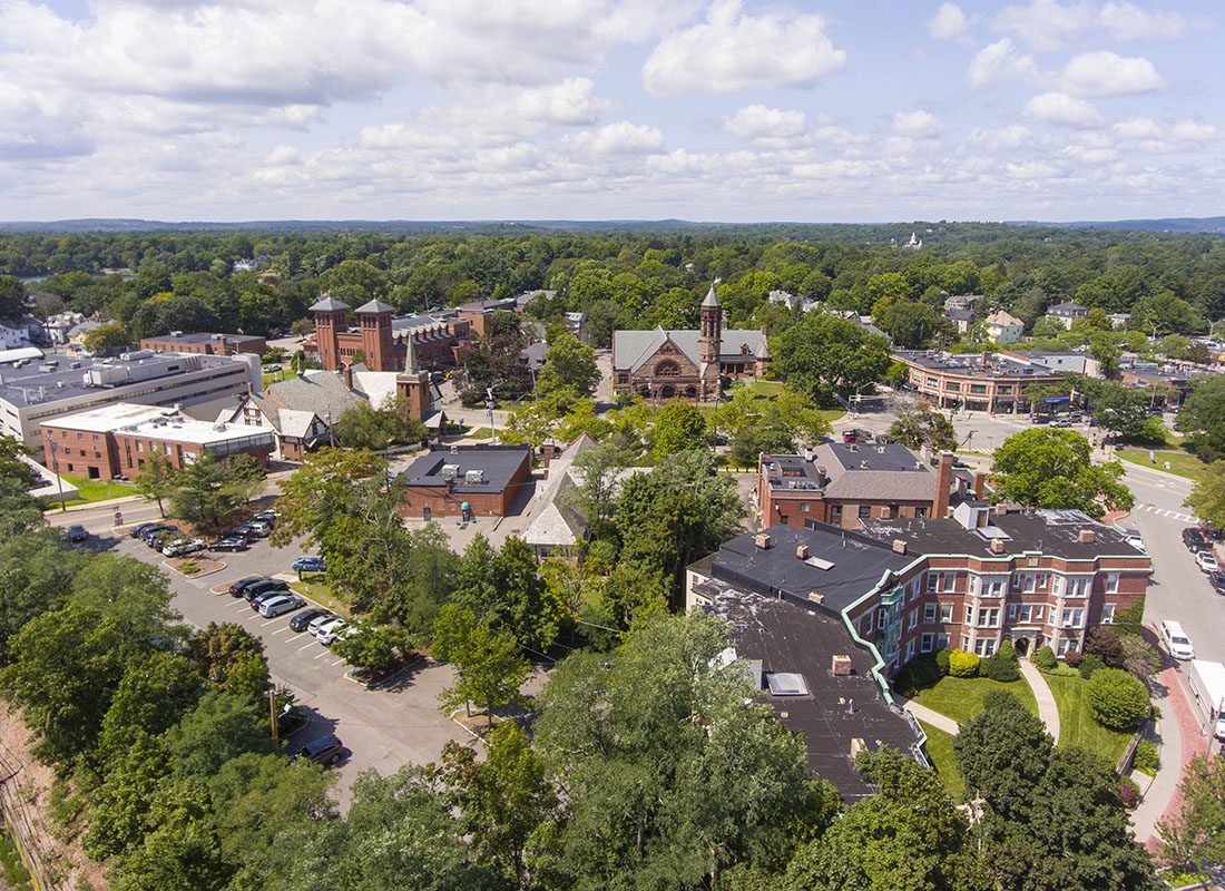Westborough, MA - Aerial View of Commercial and Residential Buildings Surrounded by Green Foliage in Westborough Massachusetts on a Sunny Day