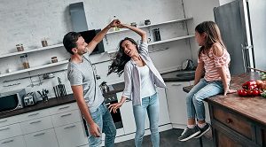 family dancing in kitchen